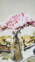 Close-up of pink flower vase on table
