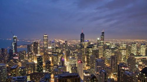 Aerial view of illuminated buildings in city