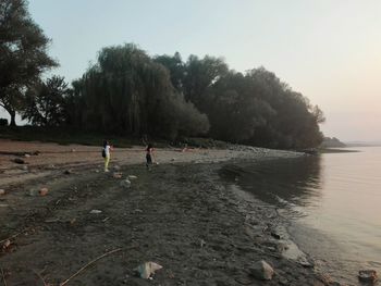 People on beach against sky