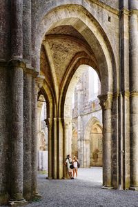 Tourist walking in san galgano abbey, tuscany, italy