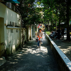 Man riding bicycle on street in city