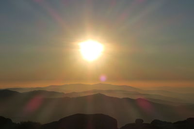 Scenic view of silhouette mountains against sky during sunset