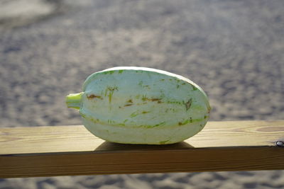 Close-up of lemon slice on wood