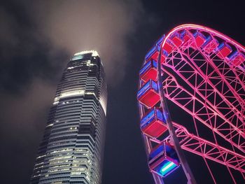 Low angle view of illuminated ferris wheel at night