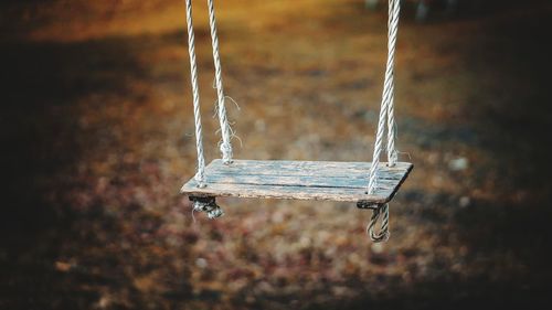 Close-up of swing hanging at playground