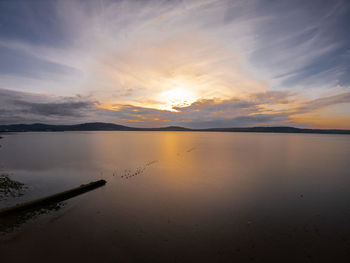 Scenic view of lake against sky during sunset