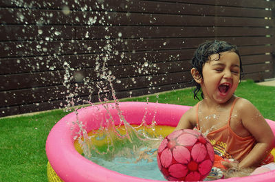 Cute girl playing in wading pool