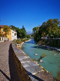 Scenic view of river against clear blue sky