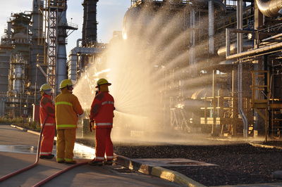 Rear view of people working in water