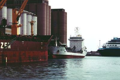 Boats in river with buildings in background