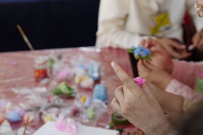 Close-up of people making craftwork at workshop