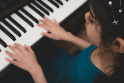 Midsection of woman playing piano