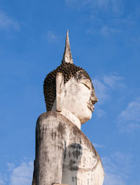 Low angle view of statue against blue sky