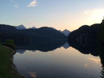 Scenic view of calm lake against sky during sunset