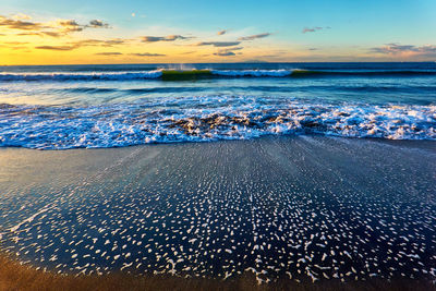 Scenic view of sea against sky during sunrise