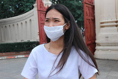 Portrait of woman against built structure