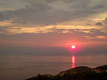 Scenic view of sea against romantic sky at sunset