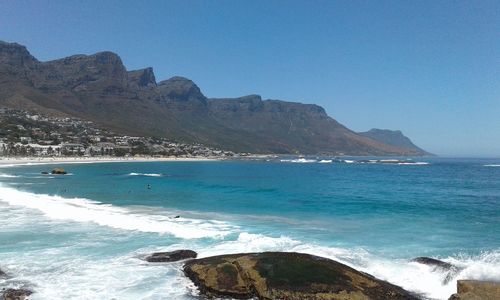 Scenic view of beach against blue sky