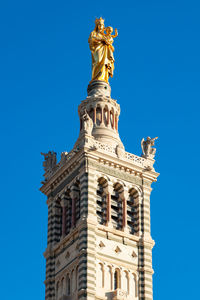 Low angle view of building against blue sky