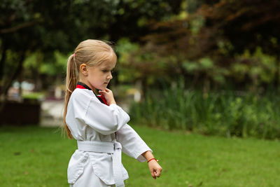 Side view of boy playing with arms crossed at park