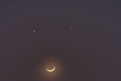 Low angle view of moon against sky at night