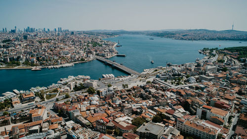 High angle view of townscape by sea against sky