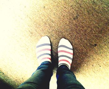 Low section of person standing on tiled floor