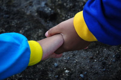 Children's hands are joined.