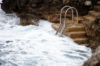 Water flowing through rocks by sea