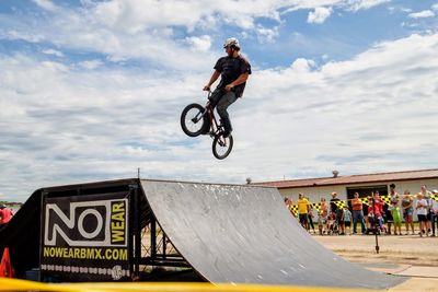 Full length of man jumping against sky