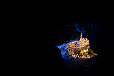 Close-up of illuminated lighting equipment against black background