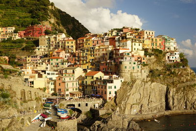 Buildings at manarola by sea on sunny day