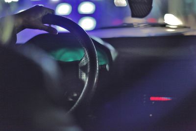 Close-up of hand on car windshield at night