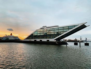 Bridge over river against sky during sunset