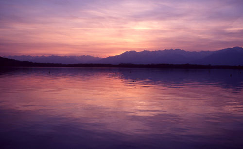 Scenic view of lake against romantic sky at sunset