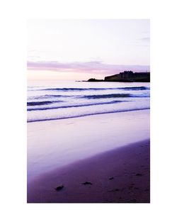 Scenic view of beach against sky during sunset