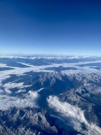 Aerial view of dramatic landscape against blue sky