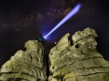 Low angle view of illuminated statue against sky at night