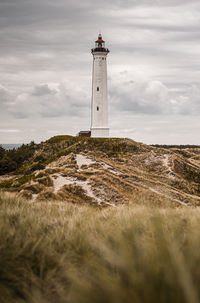 Lighthouse on grass-covered dunes
