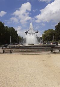 Fountain in park against sky