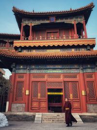 People in temple outside building