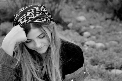 Close-up of young woman with eyes closed sitting outdoors