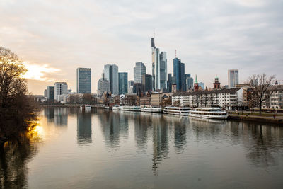 River by buildings against sky in city