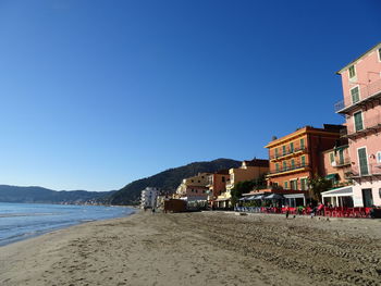 Scenic view of beach against clear blue sky