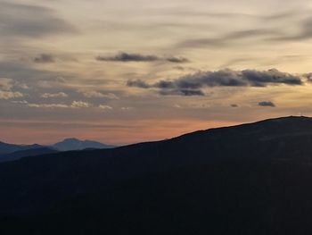 Scenic view of mountains against sky at sunset