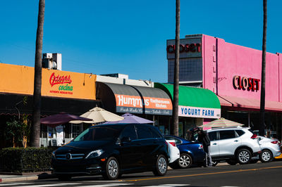 Cars on road against blue sky