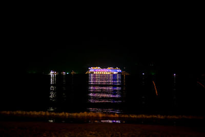 View of illuminated city against clear sky at night