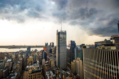 View of cityscape against cloudy sky