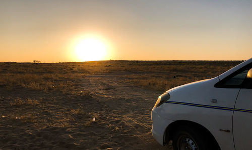 Scenic view of landscape against clear sky during sunset