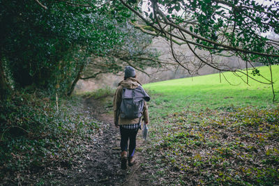 Rear view of woman standing on grass